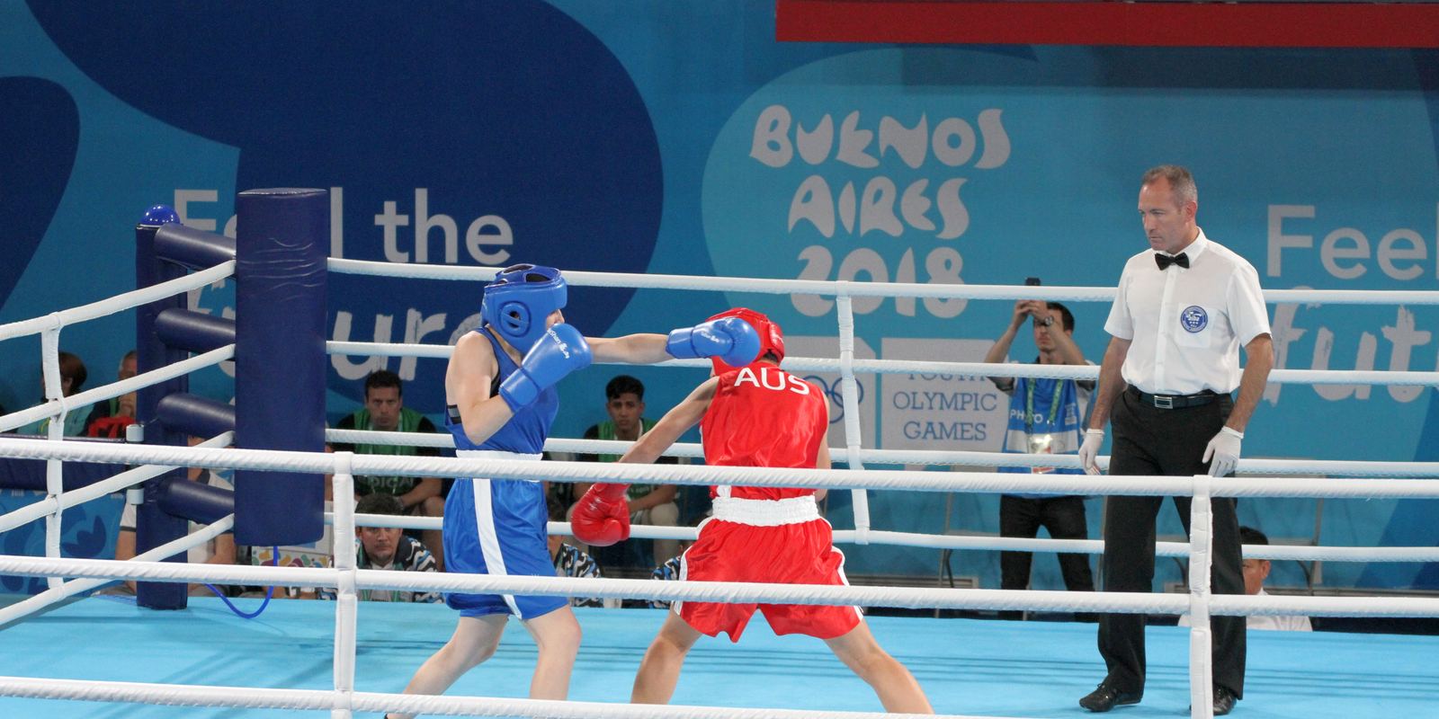 Two young boxers in headguards competing at the Youth Olympic Games