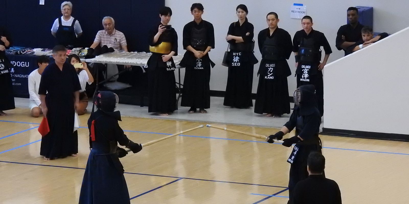 Two kendo fencers in armour facing each other with bamboo swords