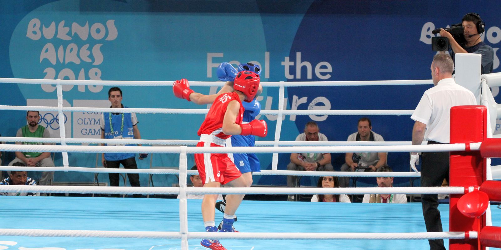 Young boxers in protective headguards and gloves